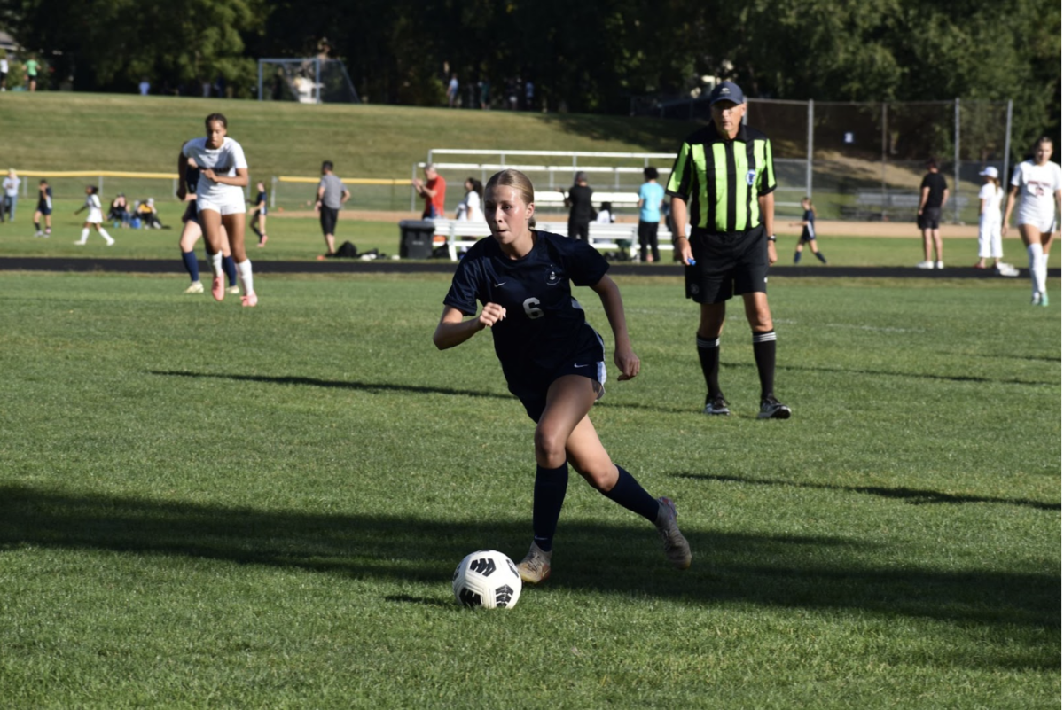 STRATEGIC STRIDE. Sophomore Maggie Sampsell-Jones moves to the goal as she heads for a shot.